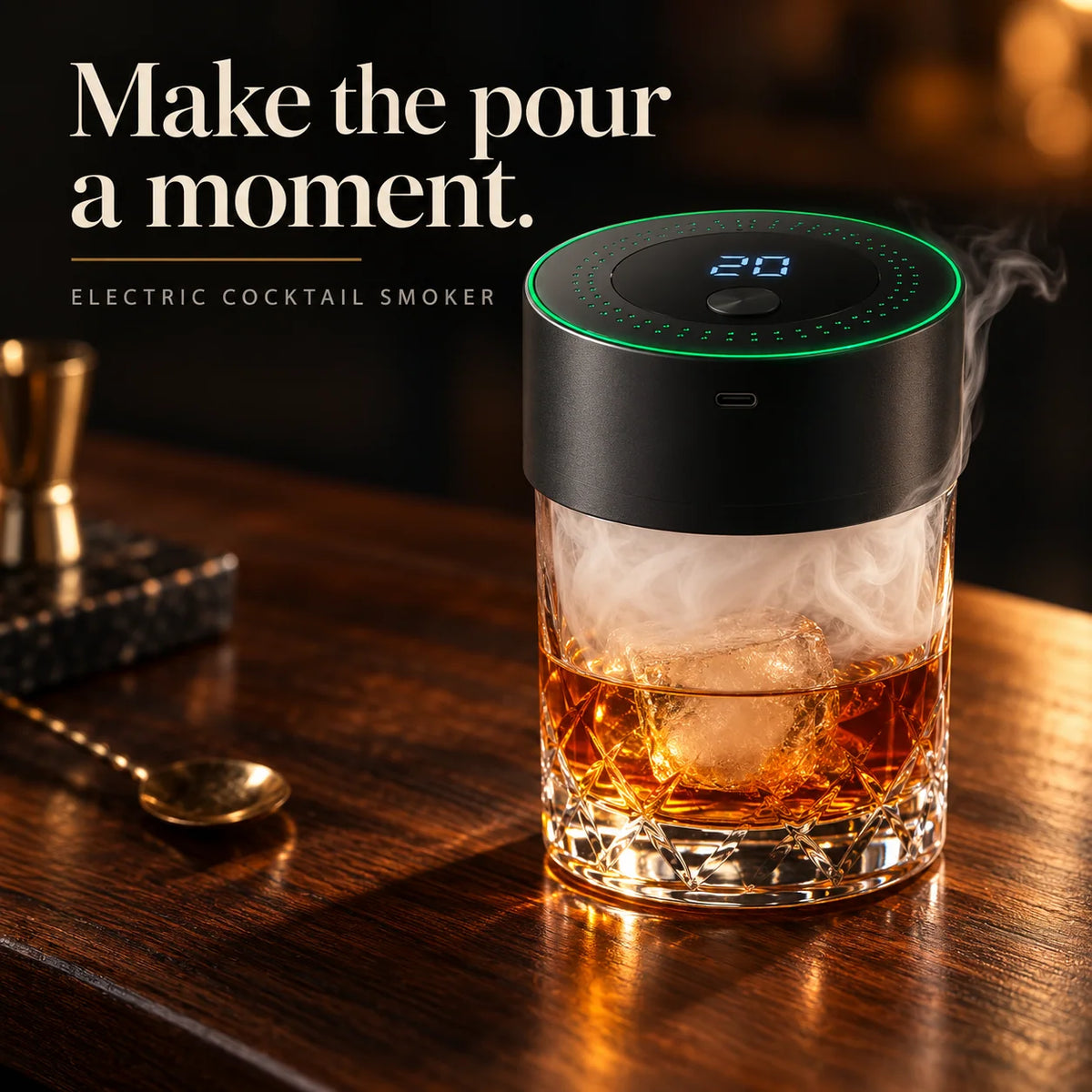 Electric whiskey smoker creating wood-smoke aroma over a cocktail in an elegant home bar setting